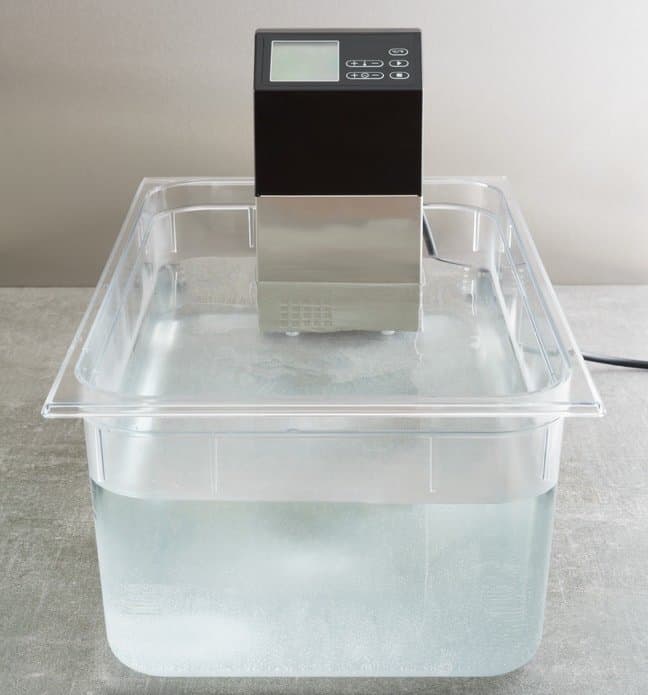 sous vide machine in polycarbonate container filled with water