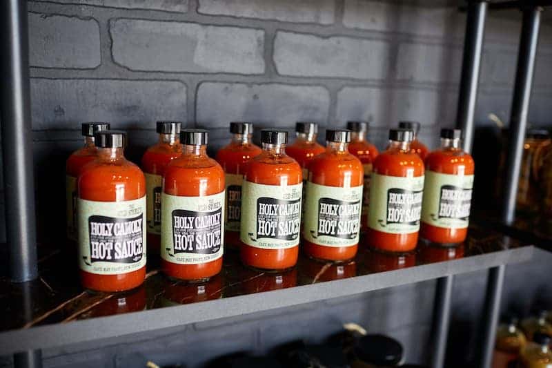 hot sauce bottles on a shelf