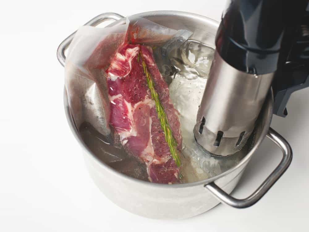 steak in vacuum sealed bag in steel pot with immersion circulator