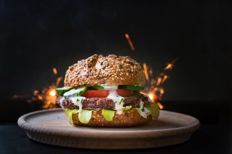 veggie burger on a plate in front of fire