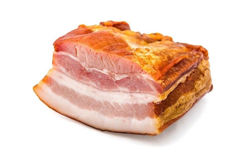 pice of bacon sliced in half to show meat and fat