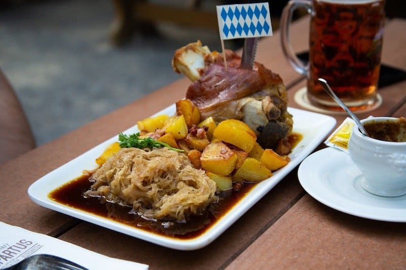 dish of sauerkraut potatoes and roasted pork leg