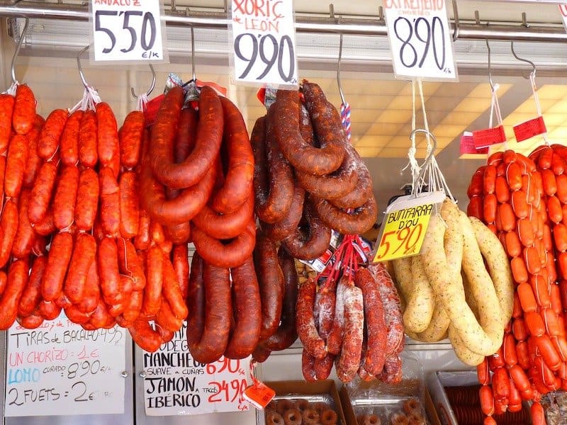 different types of sausages hanging at market