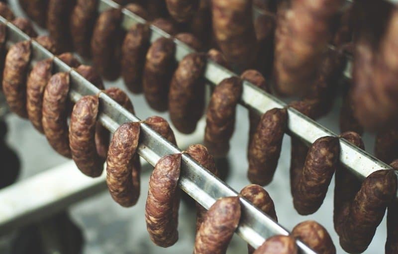 sausages hanging in smoker