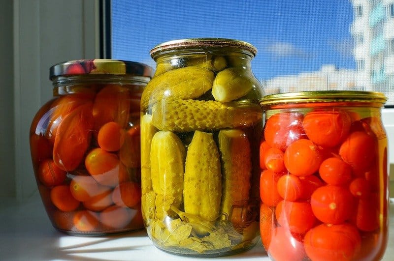 three jars next to each other each with different vegetable for fermenting