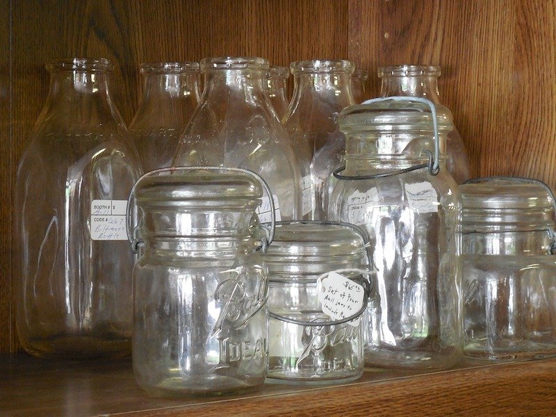 various mason jars of different sizes on a shelf