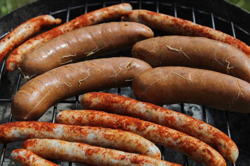 two different types of sausages on grill