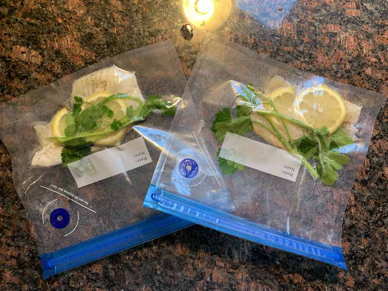 fish in sous vide bags with parsley and lemon