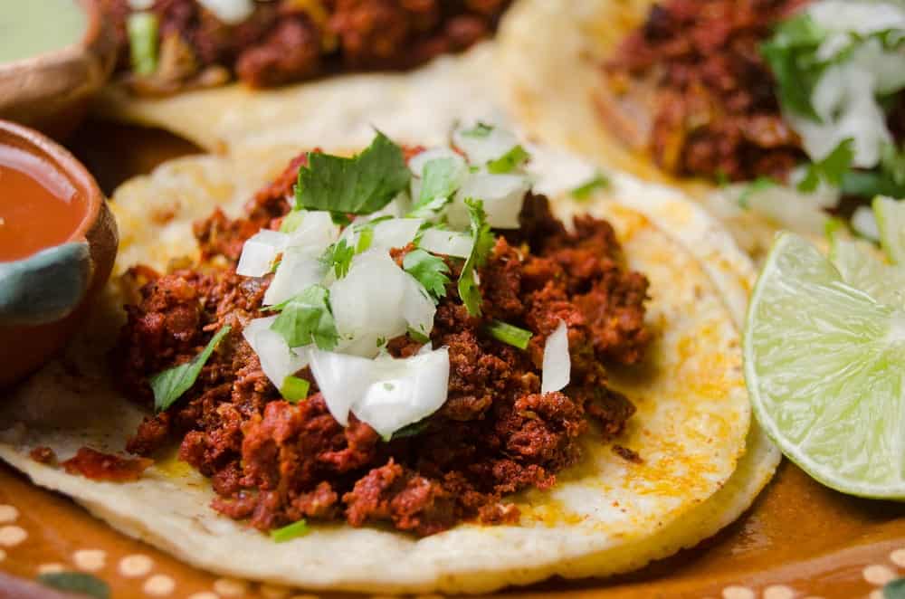 mexican chorizo on tortilla with onion and limes