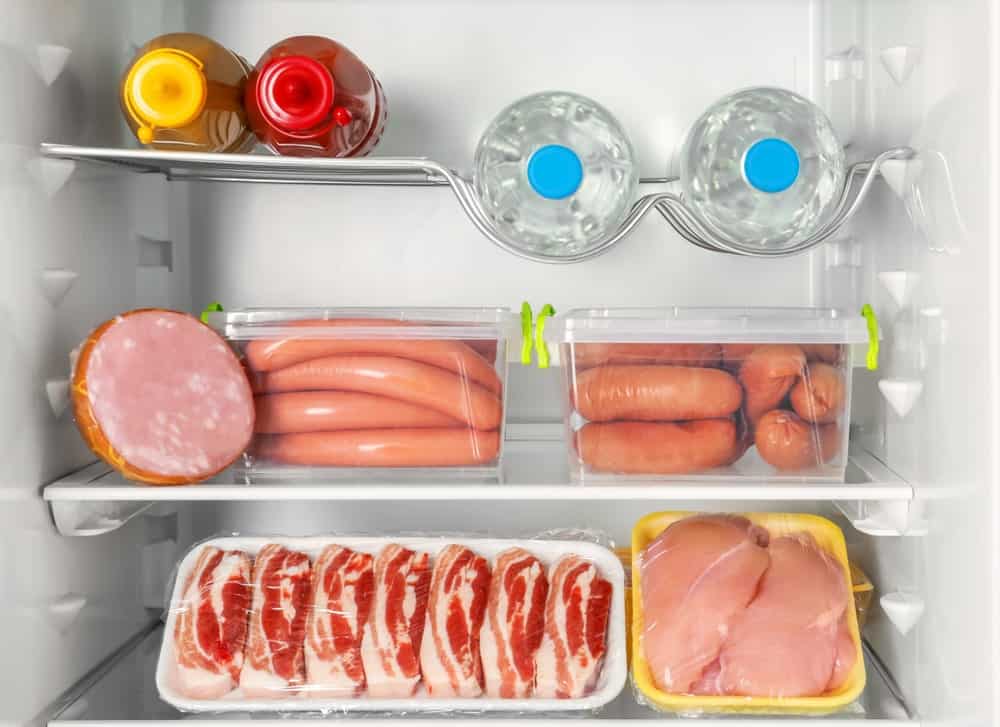 sausage meat water bottles condiments in fridge