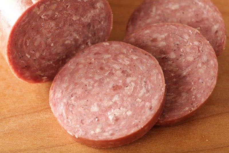 slices of summer sausage on cutting board