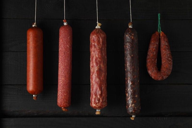 sausages hanging in smoker