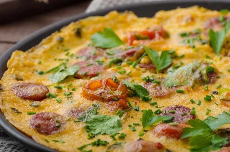 omelette with chorizo longaniza vegetables in frying pan