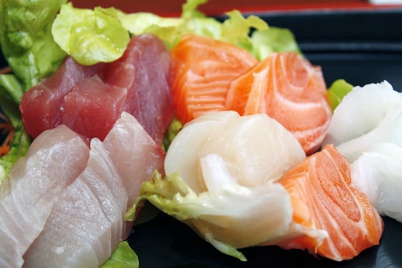 tray with four different types of sashimi