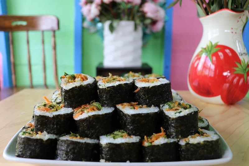 sushi stacked on plate on dining table