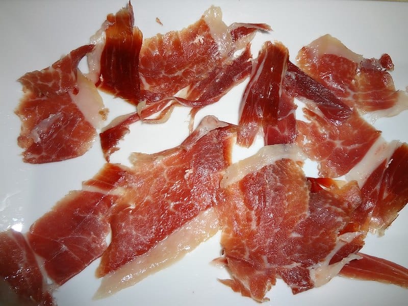 slices of serrano ham on white plate