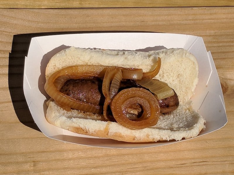 deer sausage in hot dog bun with caramelized onions