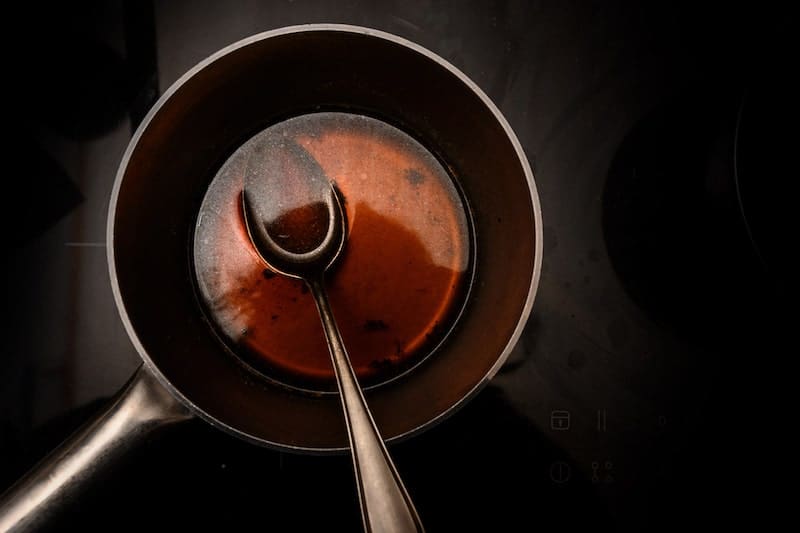 sauce in saucepan with spoon