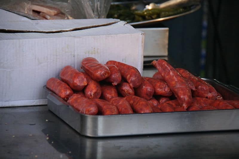 tray of red chorizo piled up on butcher counter