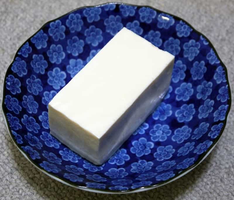 block of tofu on blue plate